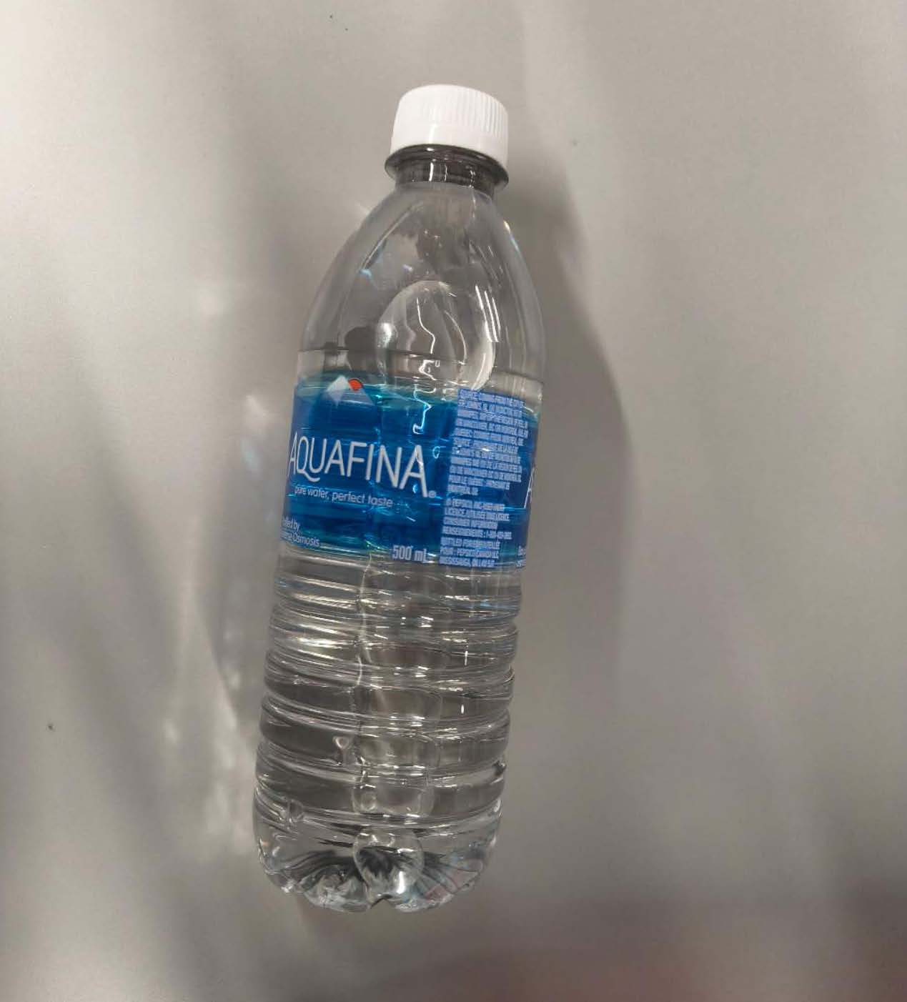 This is a side view photo of a bottle of water